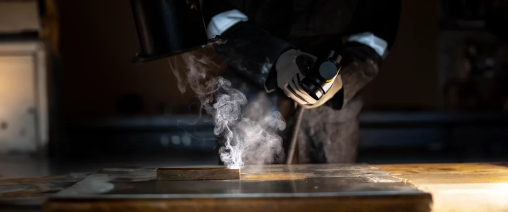 Photo of coating being removed from a metal item with a laser cleaner